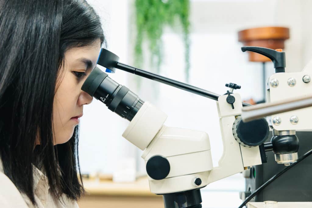 職人が顕微鏡を使って細かい模様を彫っていく